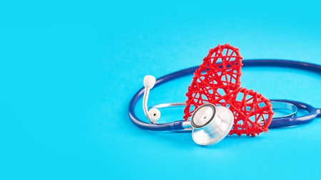 stethoscope and red heart on blue background, medical care concept, staff medical insuranceの写真素材