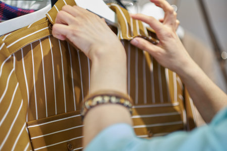 woman hands buttoned up washed shirt and set it to be in good shape before getting dried on hanger.