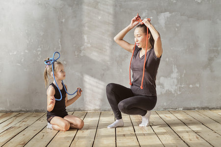 happy woman and little girl study in classroom. teacher and teacher in the dance class. individual...
