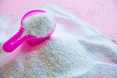 Measuring scoop with laundry powder on pink backgroundの写真素材
