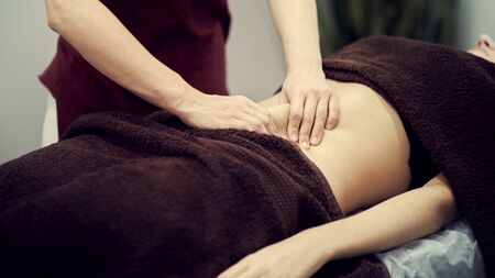 Treatment massage for weight loss in spa salon. Massage back for woman. Spa massage for correction figureの写真素材