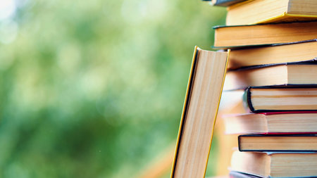 pile of old books lie on the table. home library. concept of vacation from gadgets in nature