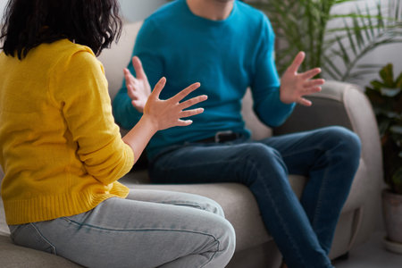 sad wife and husband, angry couple in bedroom. unhappy couple concept. usband and wife are sitting on the couch, looking away from each other. husband is not ready to have a dialogue.の写真素材