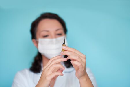 doctor or scientist in laboratory holding a syringe with liquid vaccines for children or older adults, or cure animal diseases. Concept:diseases,medical care,science, anesthesia,euthanasia,diabetes.の写真素材