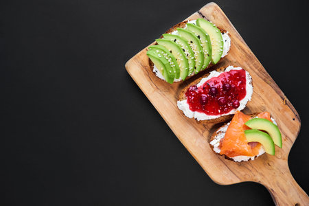 different Sandwich with avocado and smoked salmon, red raspberry and cranberry jam.