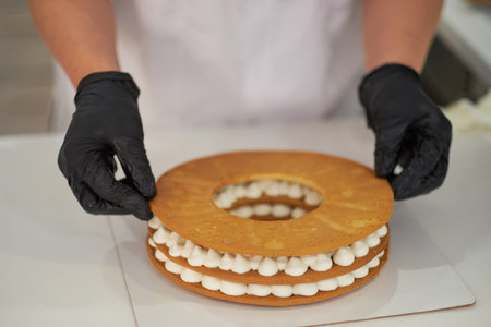 Chef decorating with a pastry bag with cream.