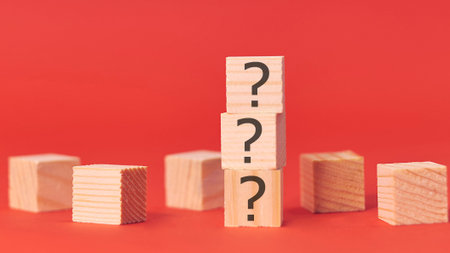 wooden blocks with black question marks