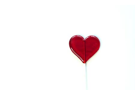 red heart shaped lollipop isolated on a white backgroundの写真素材