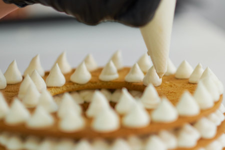 Chef decorating with a pastry bag with cream