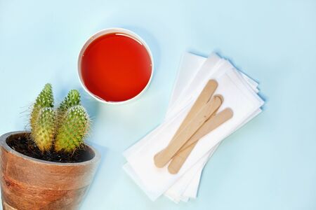 set of means of hair removal on a blue background. Wax strips. Minimalism, choice. top view, flatlay photoの写真素材