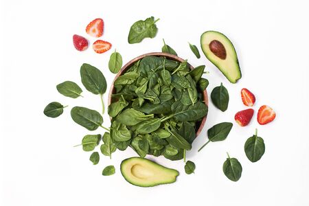 avocado with spinach and coriander on a rustic wooden table top viewの写真素材