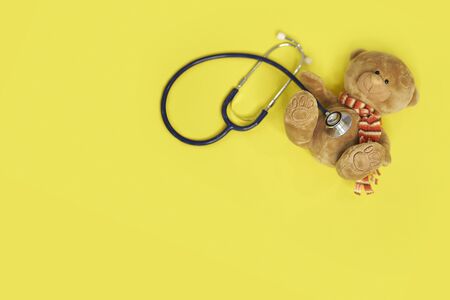 Stuffed teddy bears animal presented as a pediatrician holding a stethoscope with copy space on blue isolated backgroundの写真素材