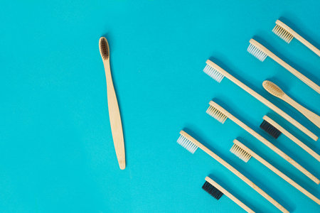 Wooden toothbrushes on a blue background. zero waste concept. dental care without platysik.