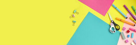 School supplies, stationery on yellow background - space for caption. Child ready to draw with pencils and make application of colored paper. Top view.の写真素材