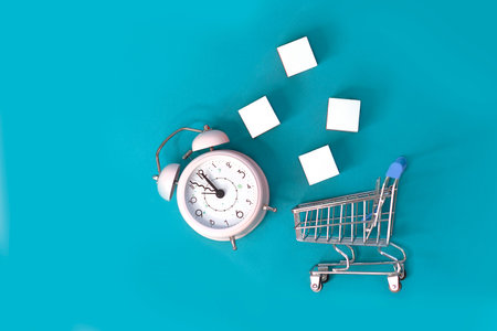 Fast delivery, time value of money concept : clock - silver shopping cart or a supermarket shopping...