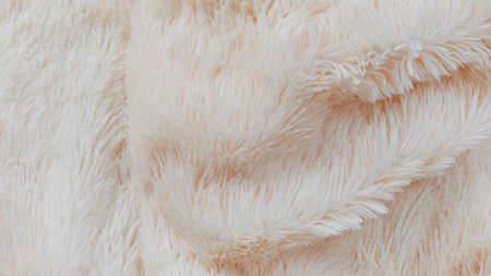 delicate soft background of plush fabric folds on white background. Copy space. Flat lay. loose folds on the fabric of faux fur of lilac color. Details of warm winter clothesの写真素材