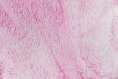 delicate soft background of plush fabric folds on white background. Copy space. Flat lay. loose folds on the fabric of faux fur of lilac color. Details of warm winter clothesの写真素材