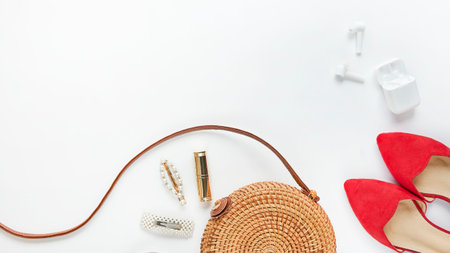 Summer outfit. Brown cross bag, headphones, straw hat. Flat lay, top view. Female, summer street...