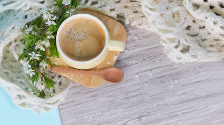 Cozy home still life: cup of hot coffee, spring flowers and opened book with warm plaid. Springtime concept, free copy space. magic bokeh background. morning affirmations conceptの写真素材