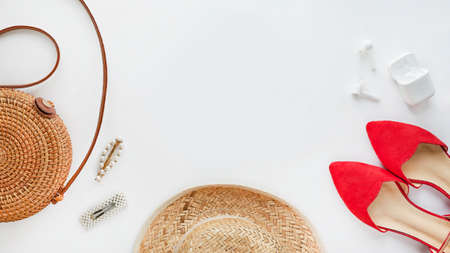 Summer outfit. Brown cross bag, headphones, straw hat. Flat lay, top view. Female, summer street style. Womens frame of accessories.の写真素材