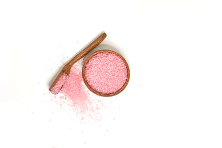 Pink salt in scoop and a wooden bowl isolated on white background. selective focus or blurry.の写真素材