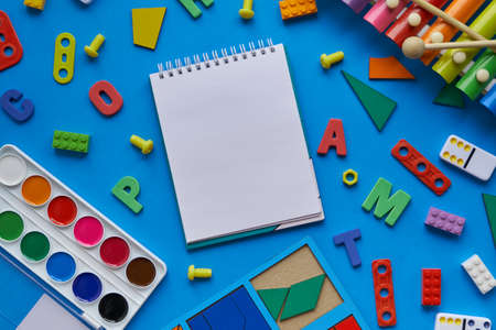 top view background with different subjects for lessons with children. creativity, harmonious growing up of a child. and an open notebook, space for textの写真素材