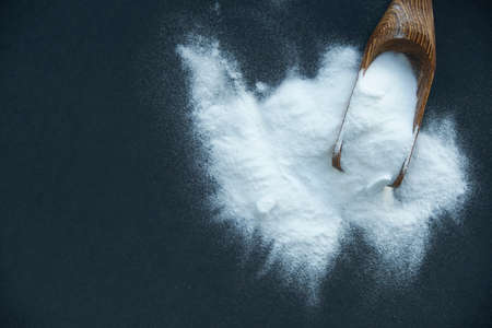 Glass bowl of baking soda. Spoonful of bicarbonate.の写真素材