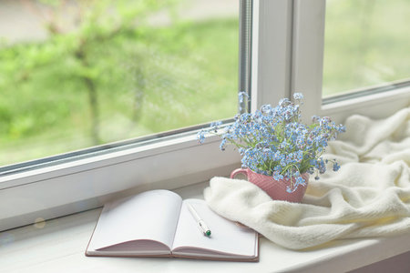white warm plaid blanket and notebook, glasses on wooden rustic bench. Photo toned, selective focus....