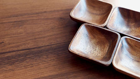 Wooden utensils for the kitchen, bowls, plates on a wooden table. The concept of natural dishes, a healthy lifestyle. Texture of wood. Wooden eco-ware. salad bowl on the brown wooden table backgroundの写真素材
