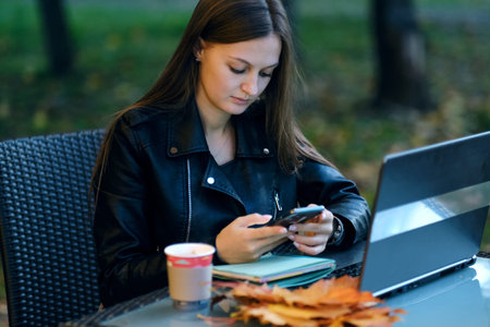 Smiling woman browsing the internet. Young lady browsing the Internet at the cafe. young woman using...