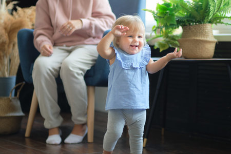 toddler strive to explore the room. the child does not want to sit still. the girl is actually...