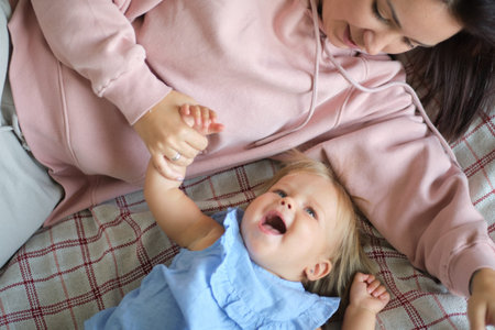 happy family. Mother and baby playing and smiling under a blanket. taking care of children