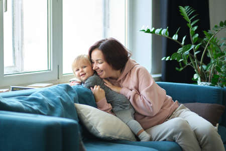 Happy loving family. mother and child girl playing, kissing and huggingの写真素材