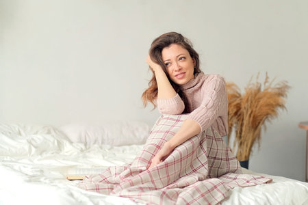 morning, leisure, christmas, winter and people concept - happy young woman with cup of coffee or tea...