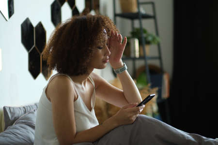 Smiling African American woman using mobile phoneの写真素材