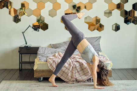 graceful woman dances in her house presenting herself on stage. happy woman dance enjoy leisure at home, stress free concept. concept of freedom and self-acceptance. dance as therapyの写真素材