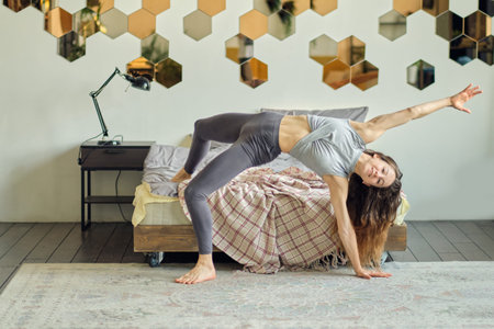 graceful woman dances in her house presenting herself on stage. happy woman dance enjoy leisure at...