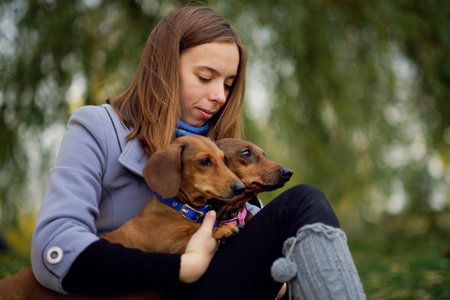 Smiling lady taking free time with her dog. Woman relaxing in the nature with her little dog....