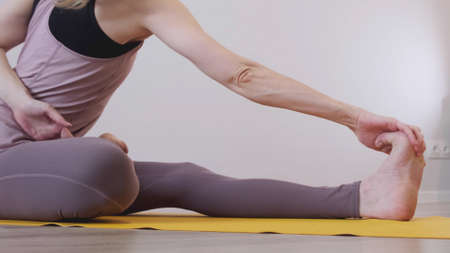 Woman meditating. young woman doing yoga exercise at home for stress relief relaxing from work.の写真素材
