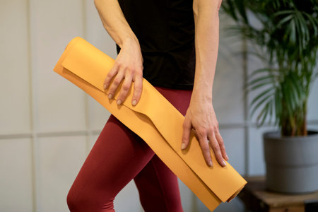 Young woman holding a yoga mat. woman practicing yoga concept natural balance between body and...