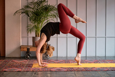 middle aged woman yoga asanas. instructor shows a pose from yoga. woman practicing yoga concept...