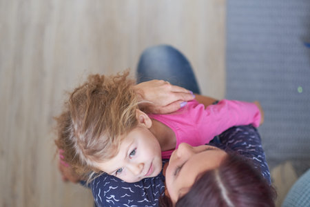 top view of mother and daughter hugs. concept of love, childish affection