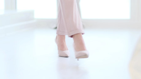 Fashionable woman wearing high heel shoes. Fashionable woman in high-heeled shoes. soft focus woman walking on white wooden floor.の写真素材