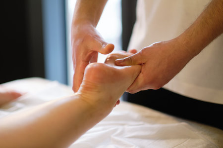Relaxing massage on the foot in spa salon indoors.の写真素材