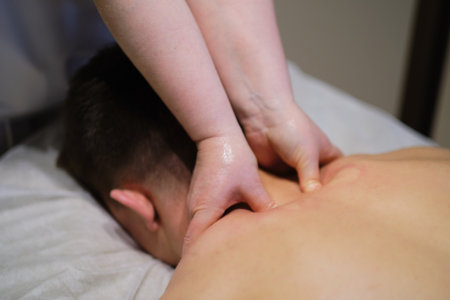 Close-up of man enjoying in relaxing neck massage . Man relaxing on massage table receiving massageの写真素材