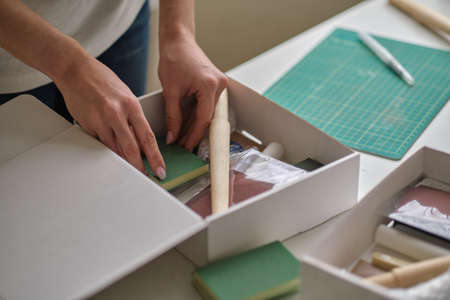 unrecognizable woman entrepreneur collects goods in a box and is about to send a parcel through a courier company. delivery service conceptの写真素材