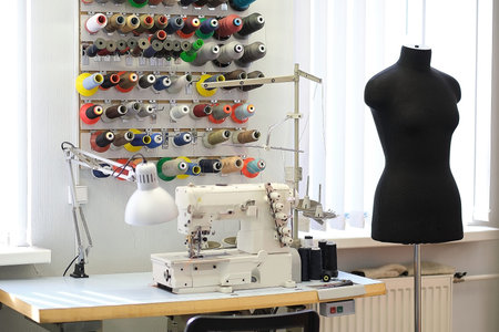 Shot of seamstress workplace. Fashion Design Studio. Sewing Machine and Various Sewing Related Items...