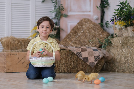 Child boy wearing bunny ears. portrait of a child sitting on the floor and holding a basket of...