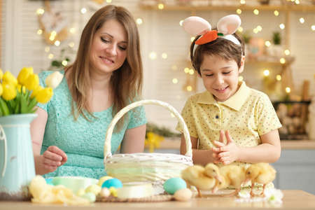 Mother and son having fun together and celebrating feast. family getting ready for easter. Little and mom decorating home. soft focusの写真素材