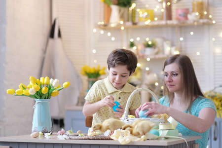 Mother and son having fun together and celebrating feast. family getting ready for easter. Little and mom decorating home. soft focusの写真素材